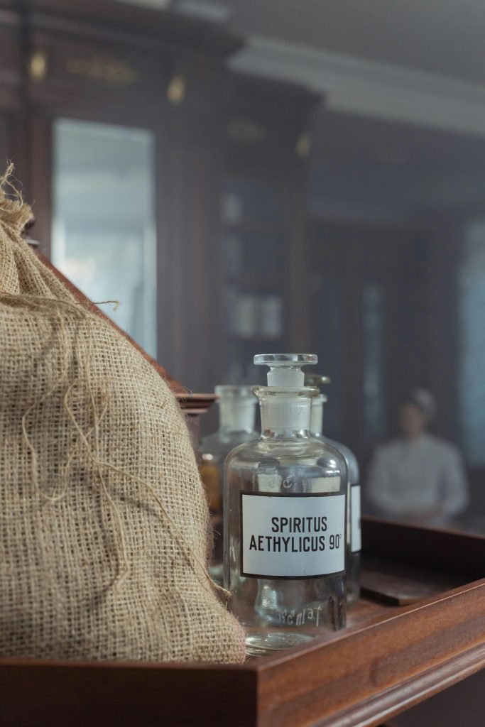 Elegant vintage glass bottle labeled Spiritus Aethylicus in a classic setting.